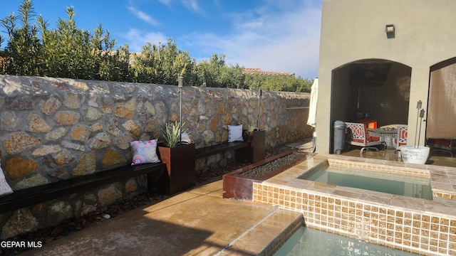 exterior space featuring a patio area, fence, and a jacuzzi