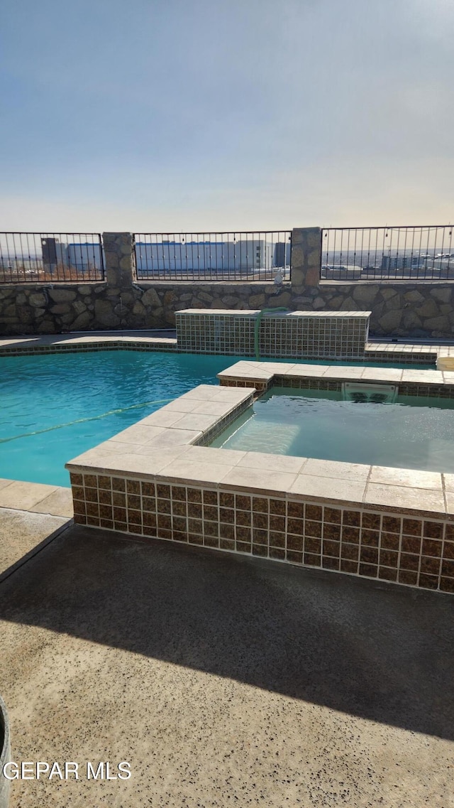 pool with an in ground hot tub