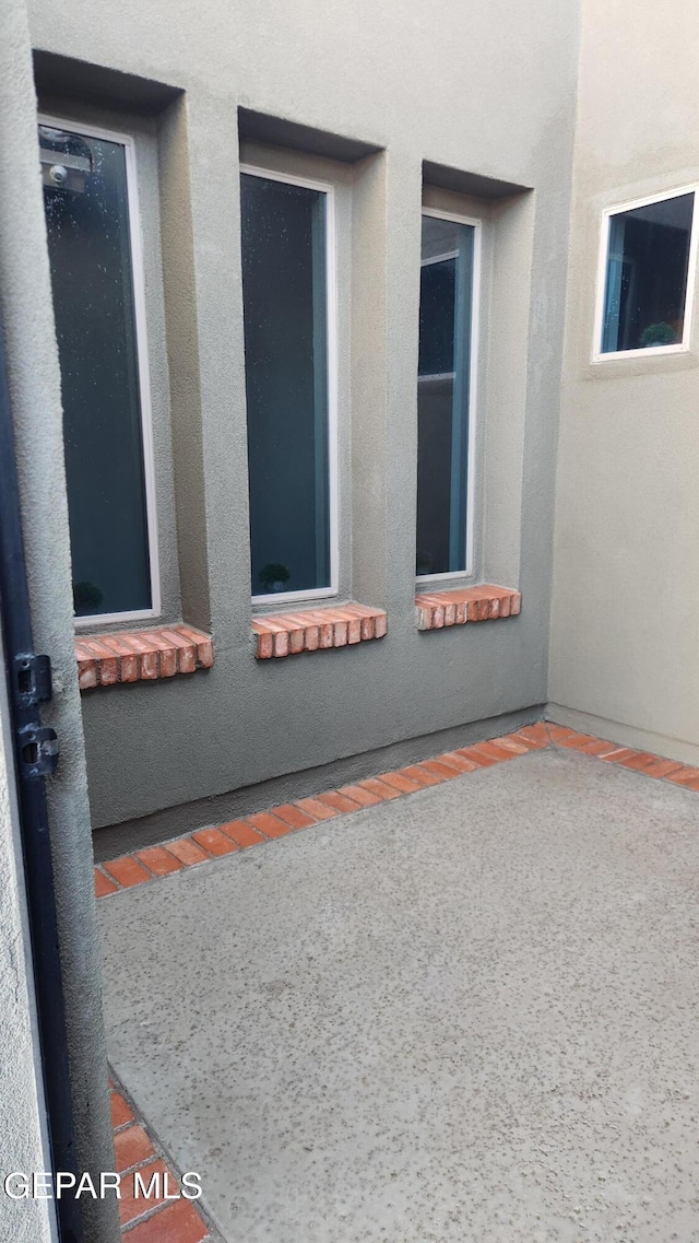 view of side of home featuring stucco siding