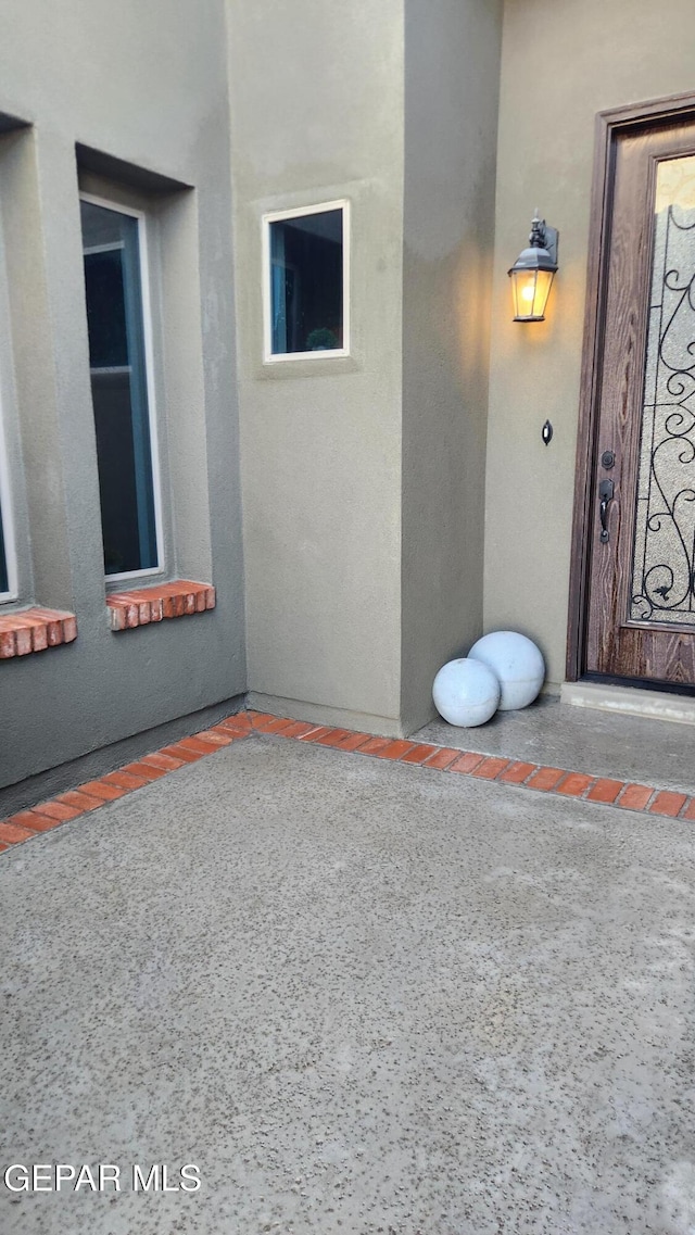 entrance to property featuring stucco siding