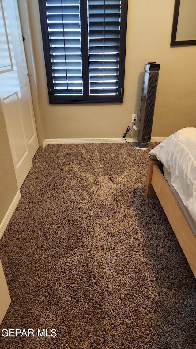 carpeted bedroom featuring baseboards