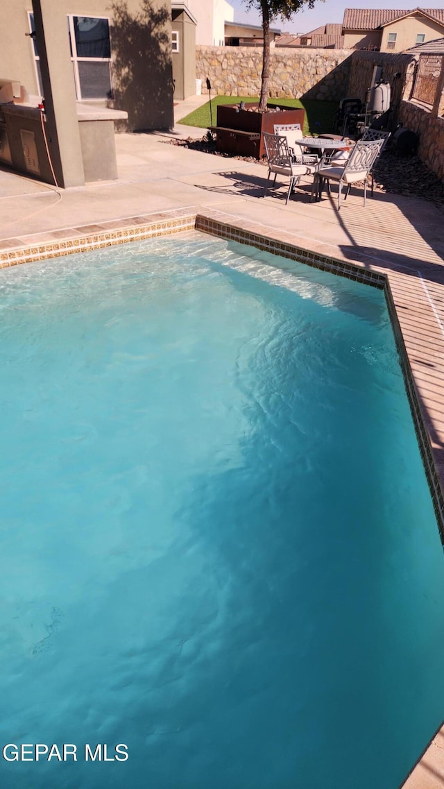 pool featuring a patio area and a fenced backyard