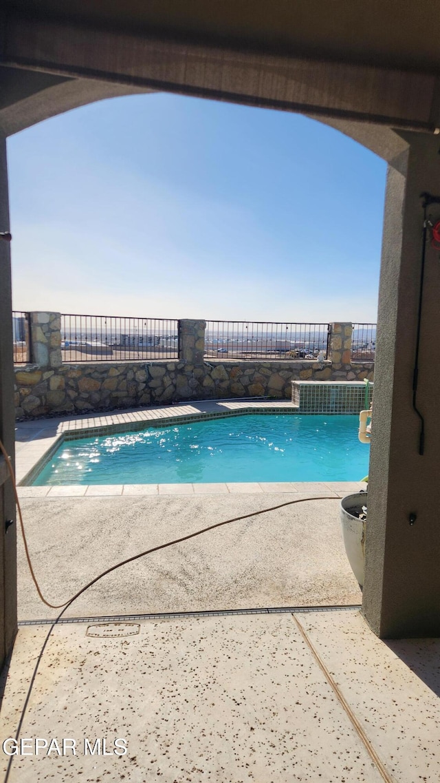 view of swimming pool with a fenced in pool