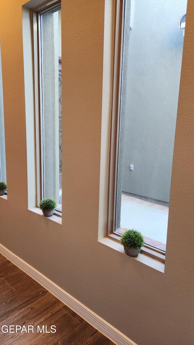 interior details featuring wood finished floors and baseboards