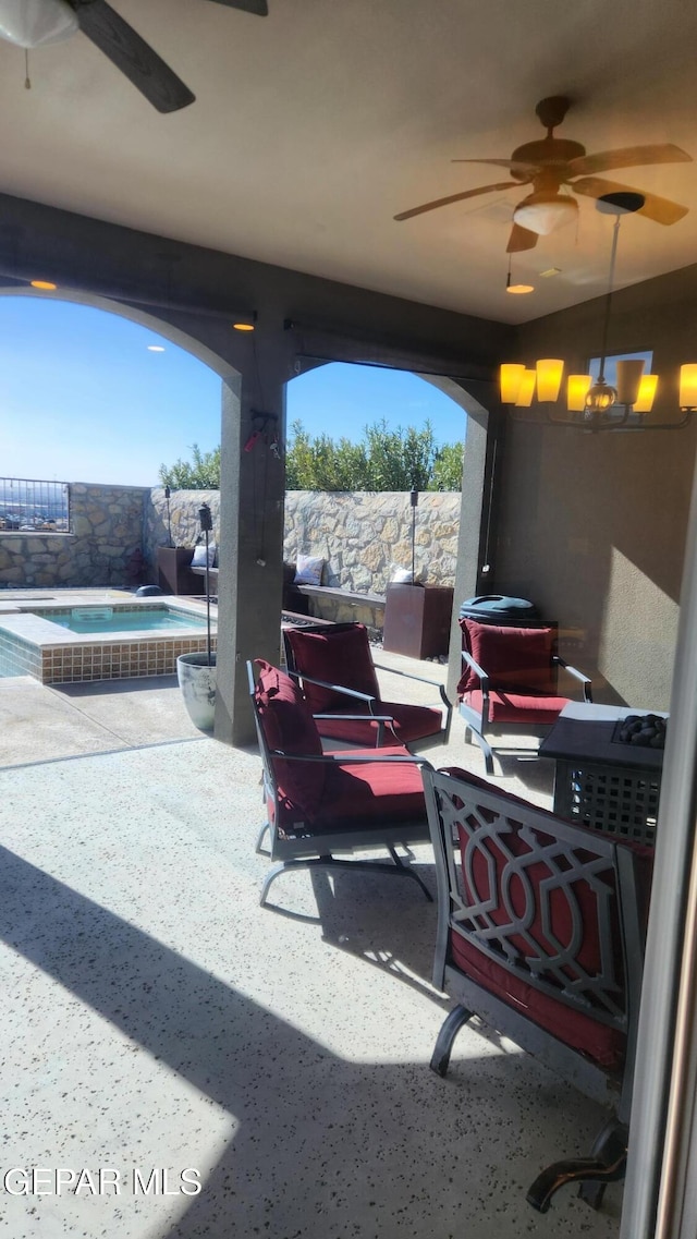 view of patio featuring an in ground hot tub, fence, a fenced in pool, and a ceiling fan