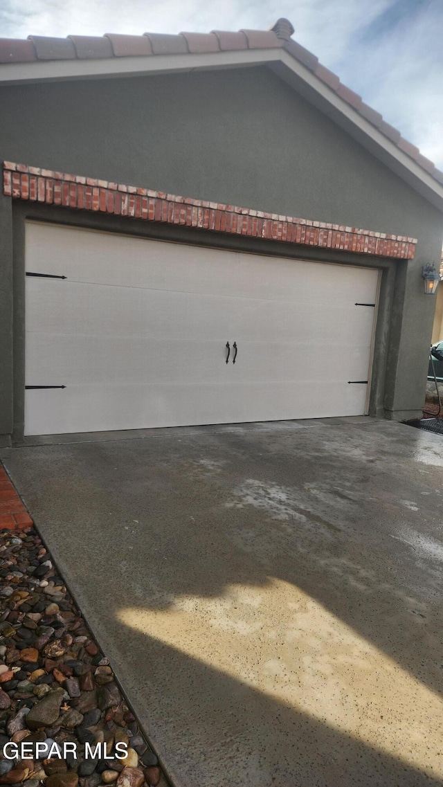 garage with concrete driveway