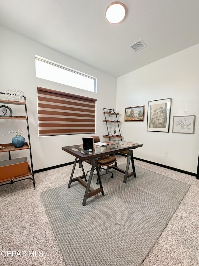 office space featuring carpet, visible vents, and baseboards