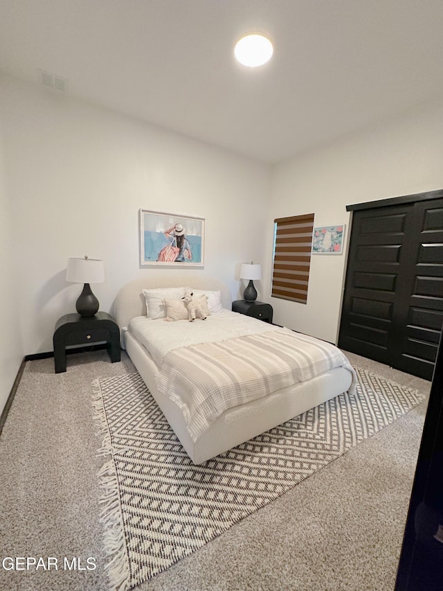 carpeted bedroom featuring visible vents and baseboards