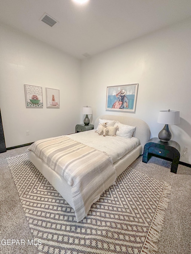 carpeted bedroom featuring visible vents and baseboards