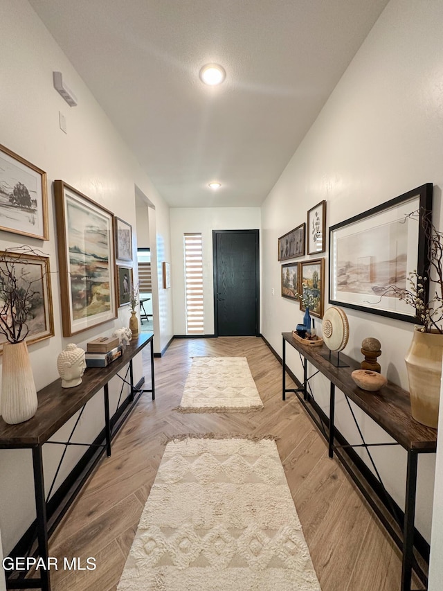 entryway featuring baseboards and light wood finished floors