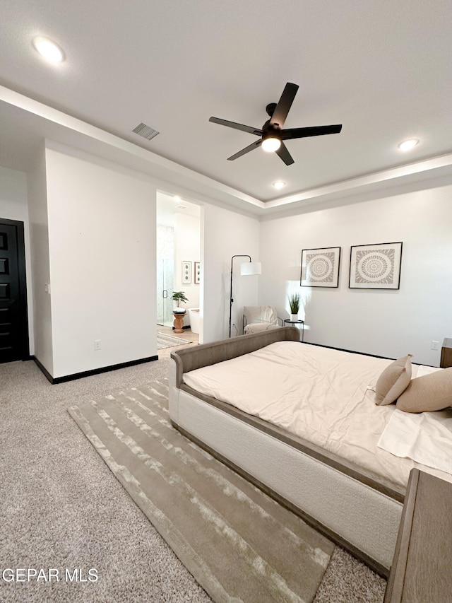 bedroom featuring visible vents, a raised ceiling, carpet flooring, and recessed lighting