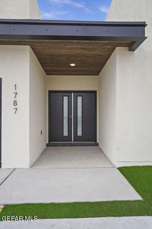 doorway to property with french doors and stucco siding