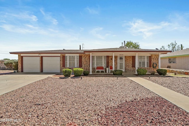 ranch-style home featuring an attached garage, a porch, and concrete driveway