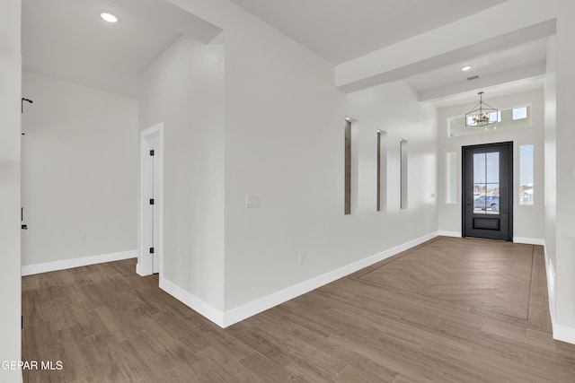 entryway featuring recessed lighting, a notable chandelier, baseboards, and parquet flooring