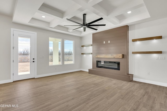 unfurnished living room with a fireplace, baseboards, coffered ceiling, and wood finished floors