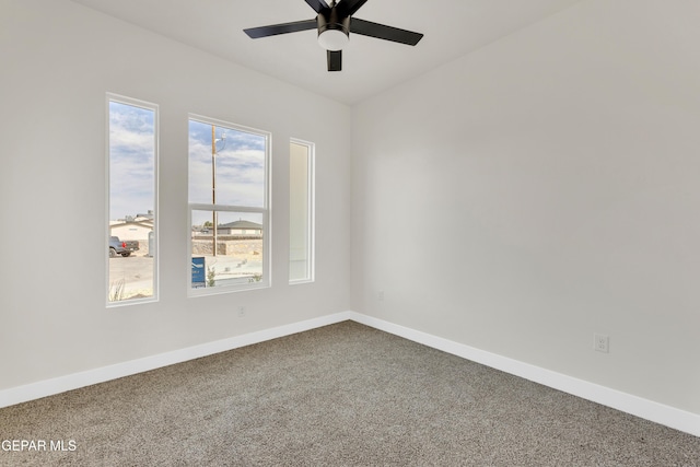 empty room featuring carpet floors, ceiling fan, and baseboards