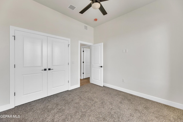 unfurnished bedroom featuring carpet floors, baseboards, visible vents, and a closet