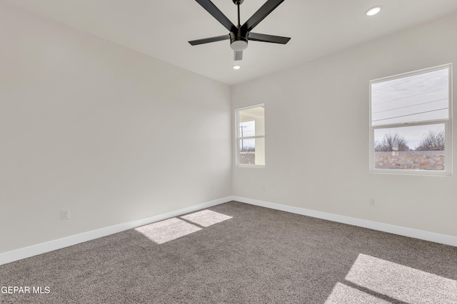 spare room with carpet floors, recessed lighting, a ceiling fan, and baseboards