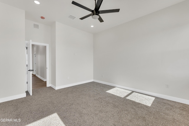 carpeted empty room featuring recessed lighting, visible vents, and baseboards