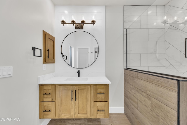 bathroom featuring a tile shower and vanity