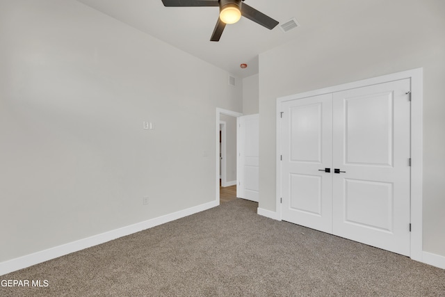 unfurnished bedroom with a ceiling fan, visible vents, baseboards, a closet, and carpet