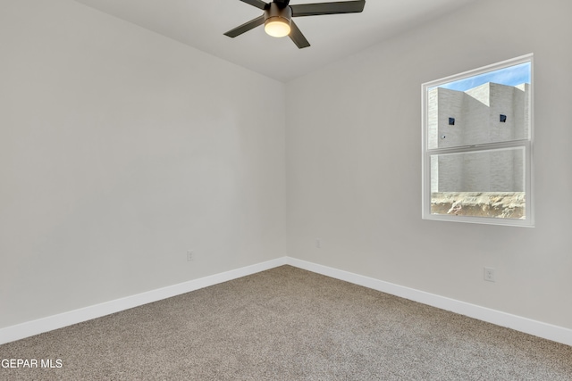 spare room with carpet, baseboards, and ceiling fan