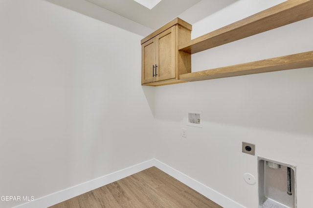 washroom featuring washer hookup, cabinet space, gas dryer hookup, electric dryer hookup, and baseboards