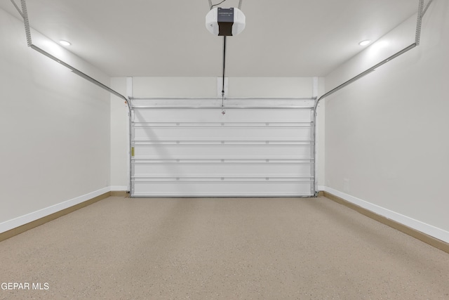 garage with a garage door opener, recessed lighting, and baseboards