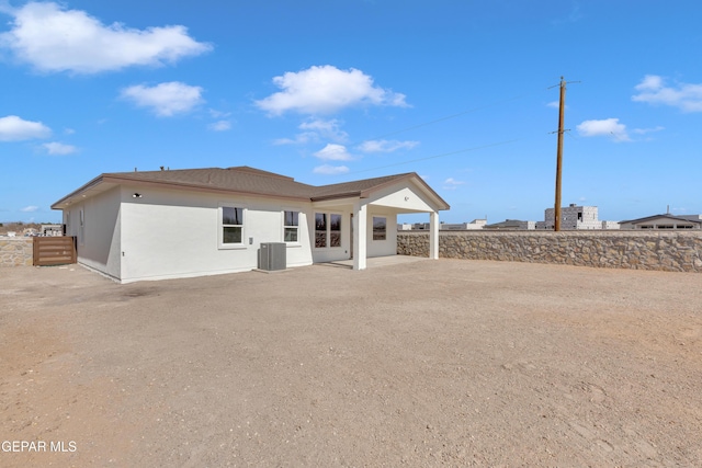 rear view of house featuring a patio, stucco siding, cooling unit, and fence