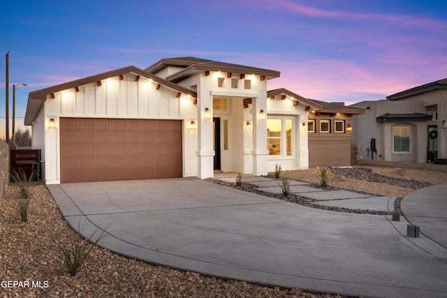 view of front of home featuring an attached garage, driveway, and board and batten siding