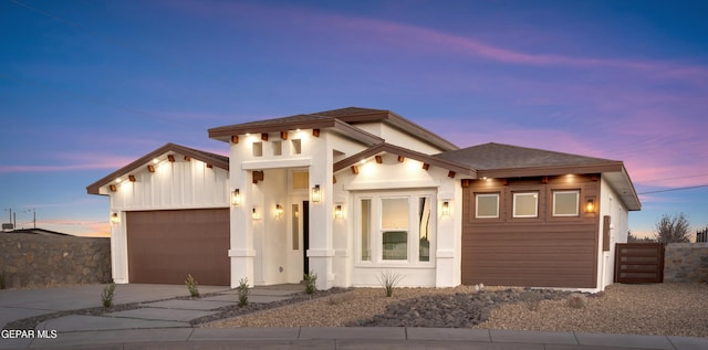 view of front facade with a garage, driveway, a shingled roof, and fence