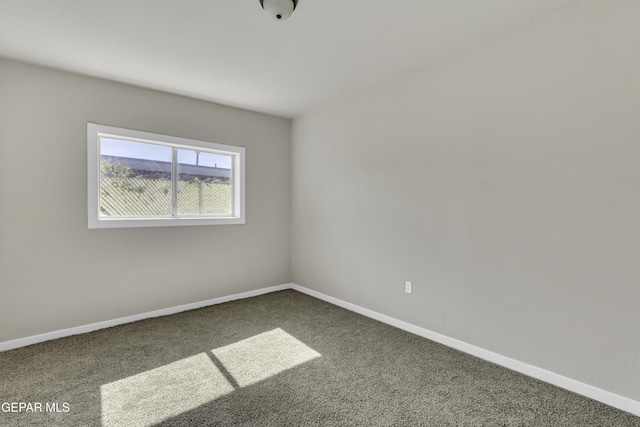 carpeted empty room with baseboards