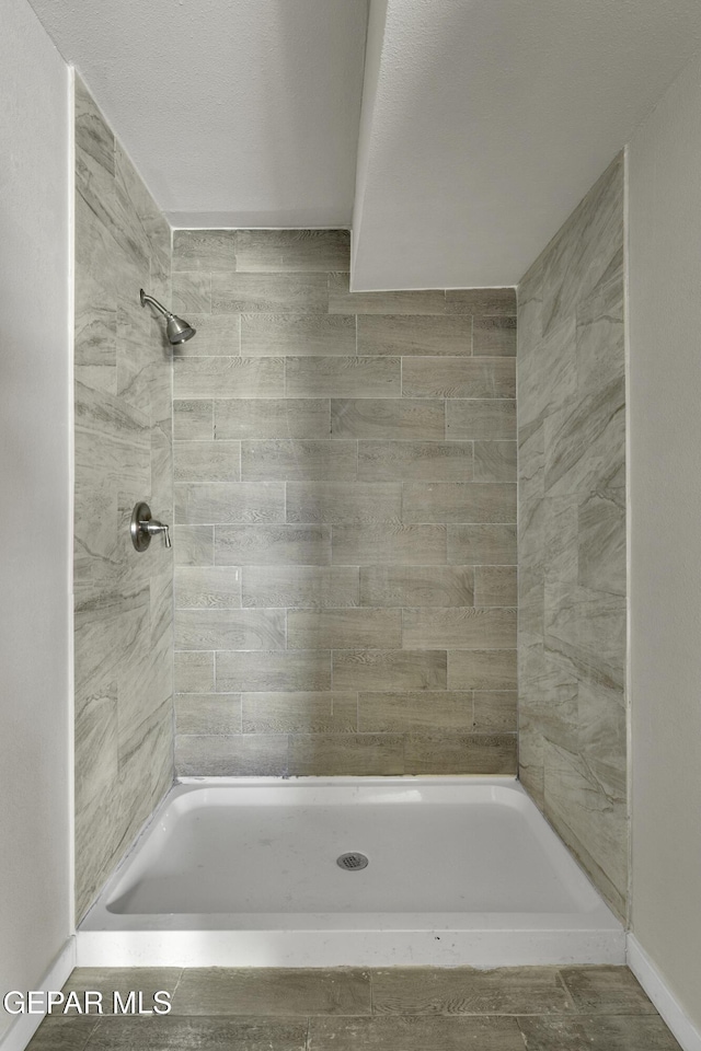 bathroom with tiled shower