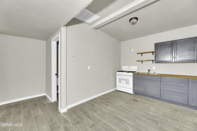 kitchen with open shelves, gray cabinets, a sink, wood counters, and white range with gas stovetop