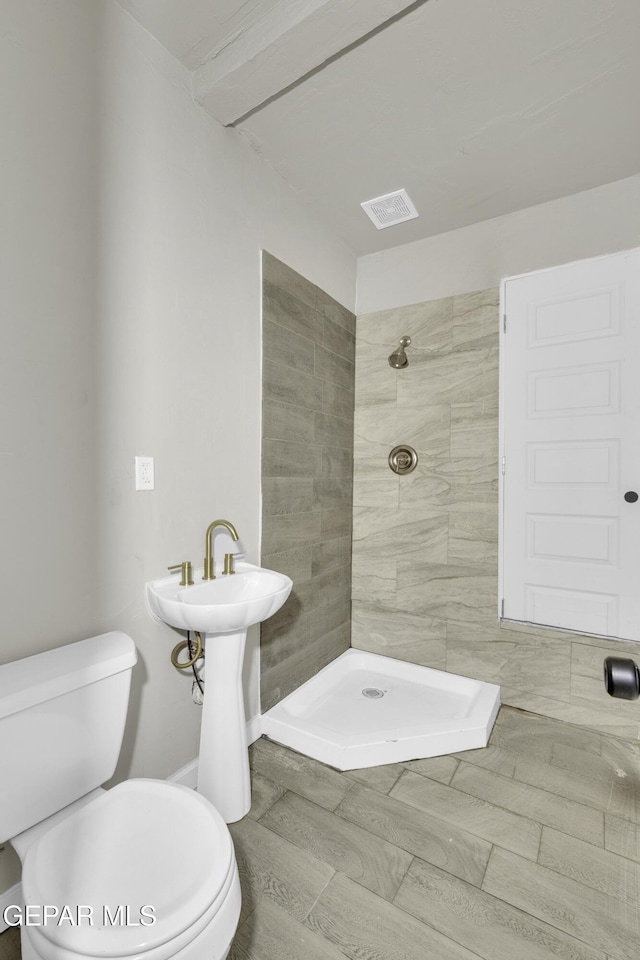 bathroom featuring a stall shower, visible vents, and toilet