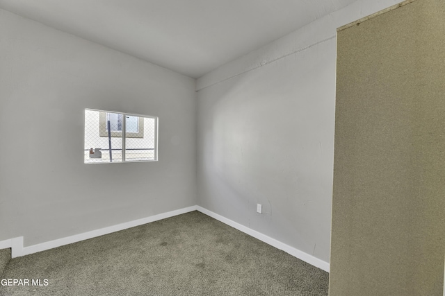 unfurnished room with carpet floors and baseboards