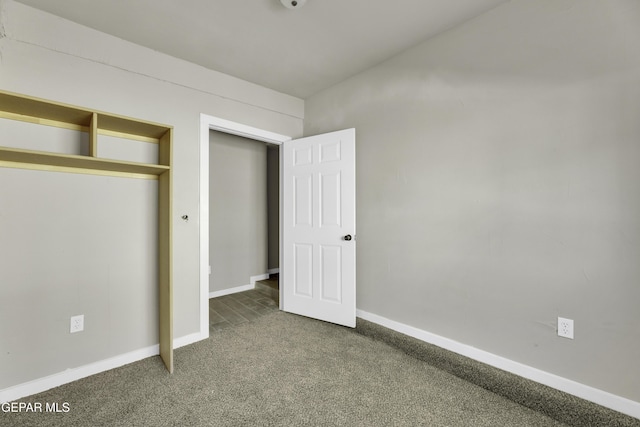 unfurnished bedroom featuring carpet floors, a closet, and baseboards