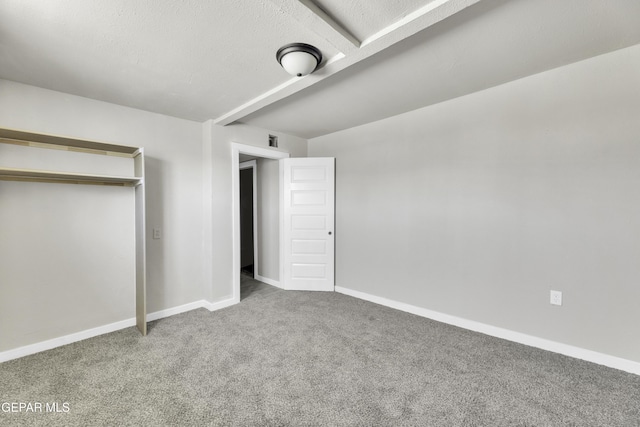 unfurnished bedroom with carpet floors, visible vents, and baseboards