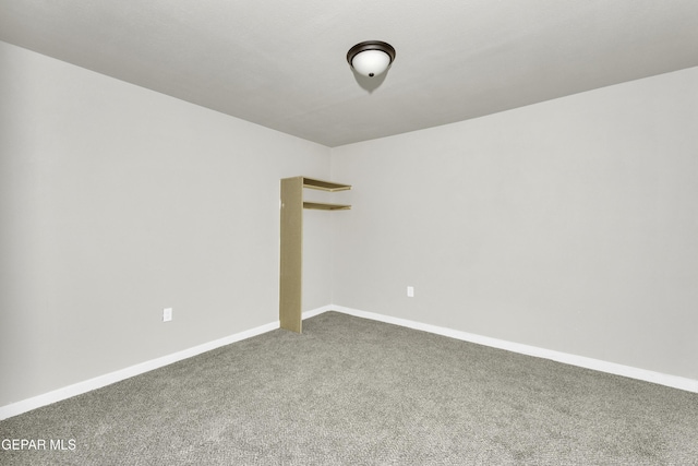 unfurnished room featuring carpet floors and baseboards