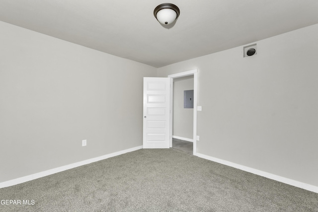 carpeted empty room with electric panel and baseboards