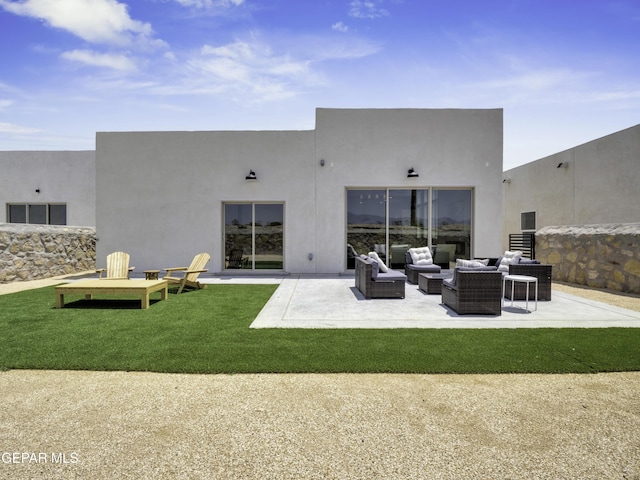 rear view of property featuring a patio area, an outdoor living space, and stucco siding