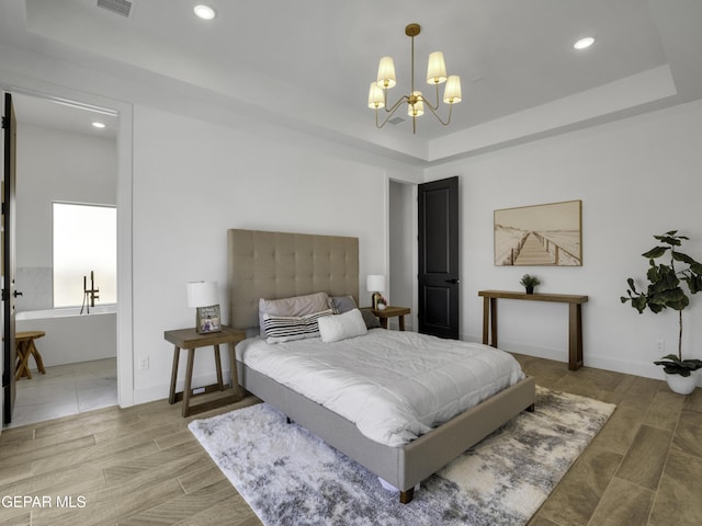 bedroom featuring recessed lighting, a raised ceiling, a notable chandelier, and light wood-style flooring