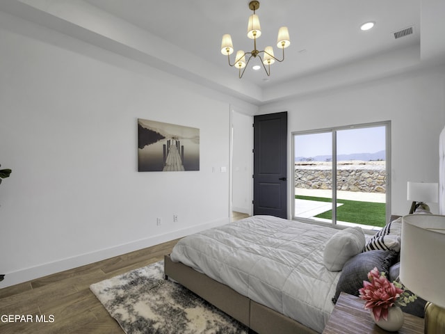 bedroom featuring baseboards, visible vents, wood finished floors, a chandelier, and recessed lighting