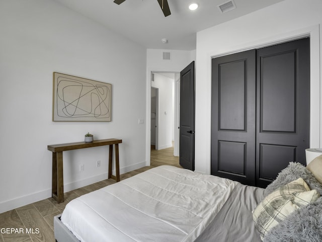 bedroom with visible vents, ceiling fan, baseboards, and wood finished floors