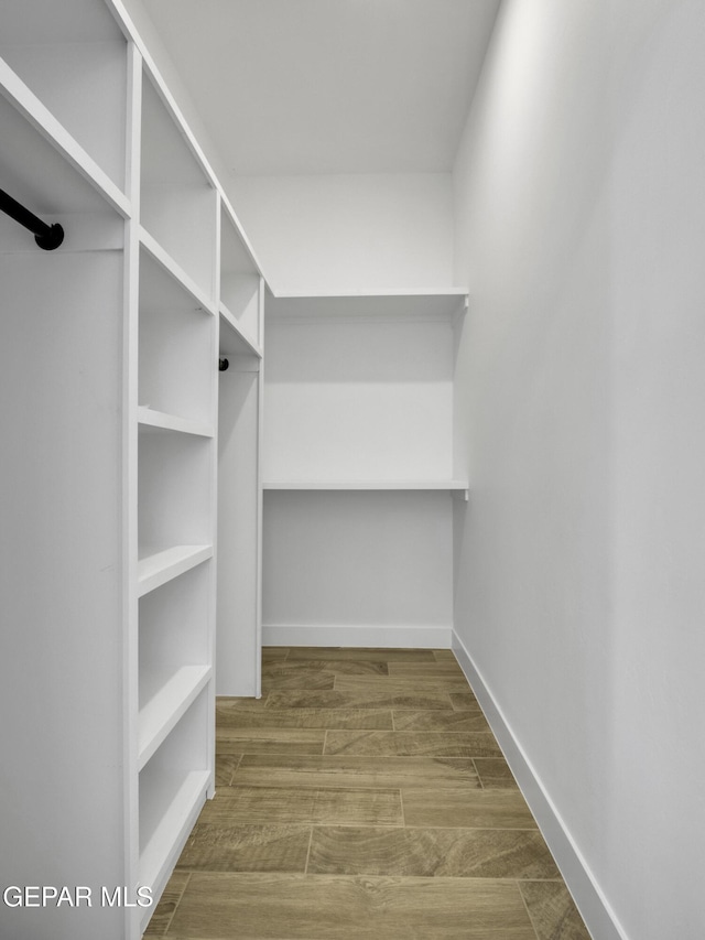 spacious closet with wood finished floors