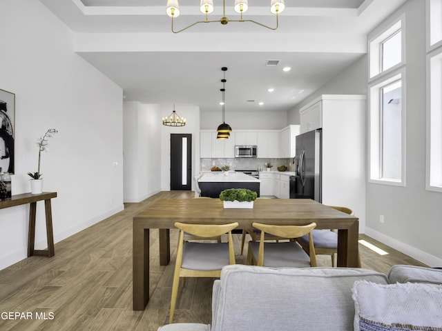 dining room with recessed lighting, visible vents, an inviting chandelier, light wood-style floors, and baseboards