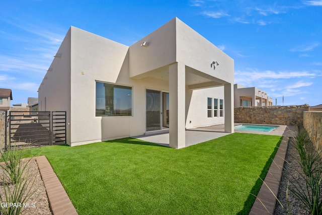 back of house featuring a patio area and stucco siding