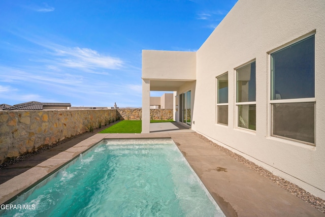 view of swimming pool with a fenced backyard