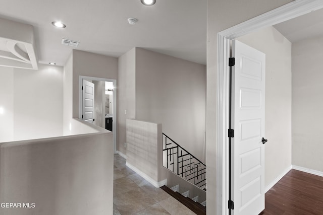 hallway featuring recessed lighting, wood finished floors, an upstairs landing, baseboards, and visible vents