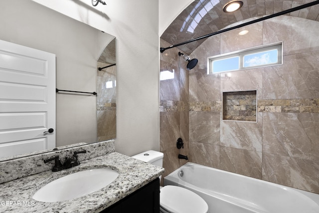 bathroom with shower / tub combination, vanity, and toilet